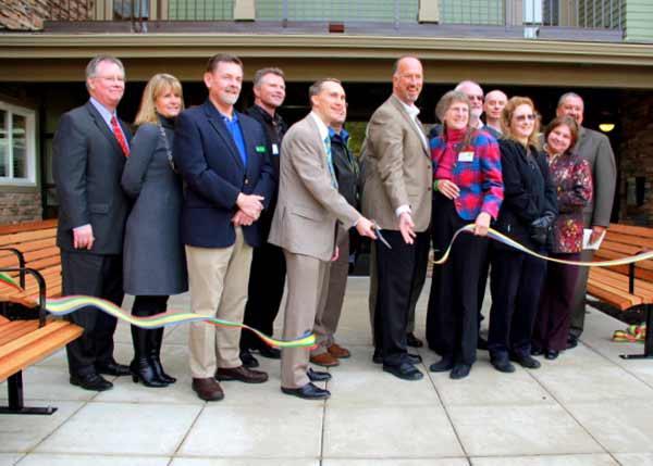 Martha & Mary CEO Chad Solvie cuts the ribbon to the Village Green Senior Apartments during the grand opening celebration Nov. 22.