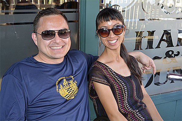 Jason Santiago and wife sit outside of the Hare & Hounds pub after watching the U.S. beat Australia 3-1 June 8.