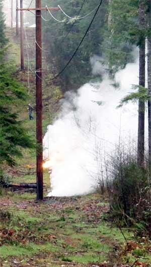 An electrical wire burns on the ground after it fell on land between Noll Road and Maranatha Lane Jan. 14. The downed wire was the cause of power outages in Poulsbo.