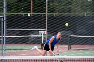 Bremerton's Courtney Wasserburger serves during a first-round match at the Olympic League girls tennis tournament at North Kitsap High School on Friday. Wasserburger and teammate Breanna Casias won the doubles tournament to earn a berth to districts.