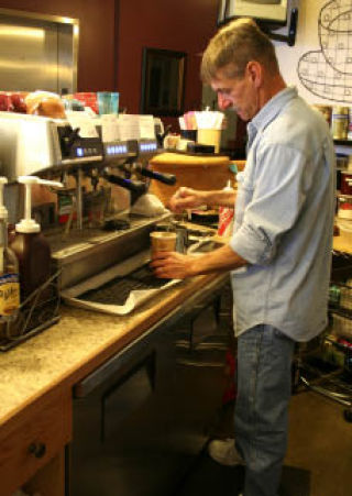 Café Noir co-owner Mike Ferrin makes a mocha at the Silverdale coffee shop. He and his wife opened the business in the Amish Touch building on Mount Vintage Way behind Target in October.