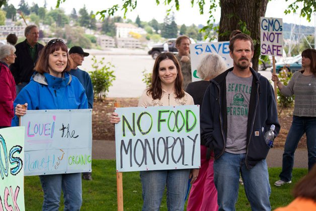 Minnie Deese and her daughter Jennifer show their signs along with Jennifer's boyfriend Derick Sharnbroich at the March against Monsanto Saturday.