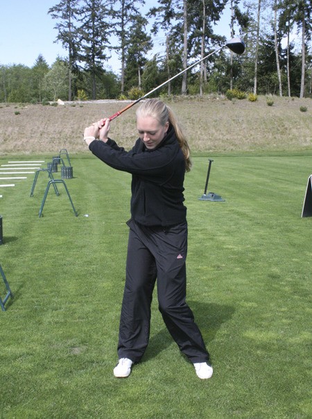 Kingston High School golfer Elle Sander demonstrates her swing Tuesday at White Horse Golf Course in Kingston.