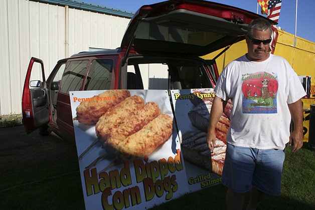 Cooky Sawyers readies his booth signs for advertising at the Kitsap County Fair & Stampede. Sawyers has been involved in fair concessions for 51 years.