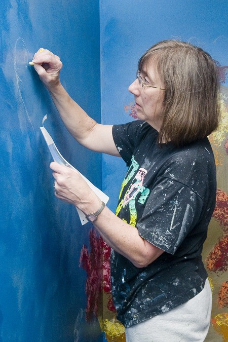 Charlene Serra helps with a mural at West Hills Elementary School in Bremerton.