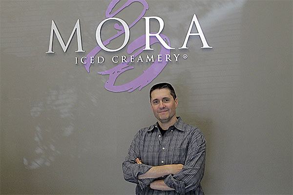 Jerry Perez stands in front of the entry way of Mora Iced Creamery’s new production plant. The facility will help Mora expand into franchising and wholesale business.