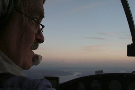 John Stasny looks out the window of his Cessna 172 last week while flying over Silverdale with a view of Mount Rainier in the distance. Stasny is a member of the Apex Property Owners Improvement Association