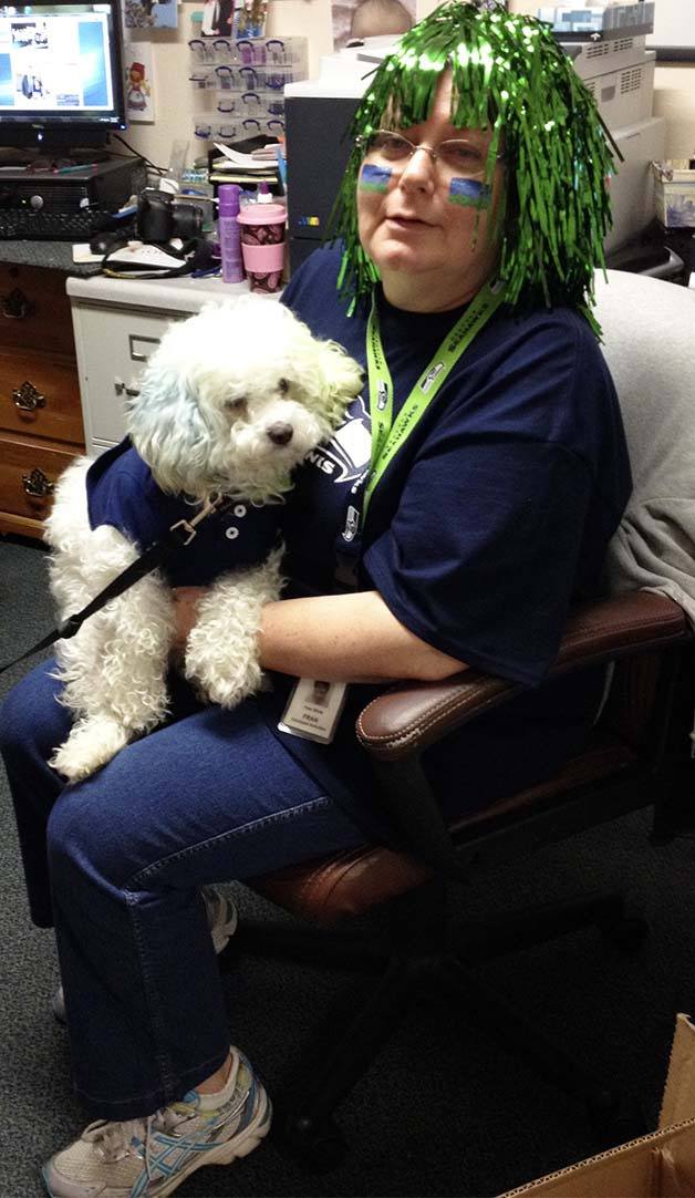 Crista Senior Living Activities Coordinator Fran White holds Charlie during a spirit day at the living facility. Residents had their faces painted