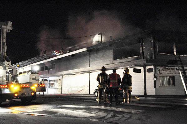 Firefighters work to quell a three-alarm blaze that did significant damage to Bay Street landmark restaurant Myhre’s last Friday night.