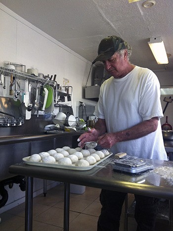Andreas Pappas prepares handmade dough for pitas.