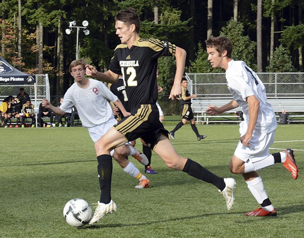 Peninsula College’s Dylan Clark dribbles upfield against the Olympic College Rangers team Oct. 31 during the last game of the 2014 fall regular season. The Peninsula College Pirates won 5-2.