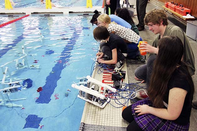 Mountain View Middle School students test out model ROVs at the Bremerton YMCA pool. Students designed and built their own ROVs and were required to troubleshoot on site.