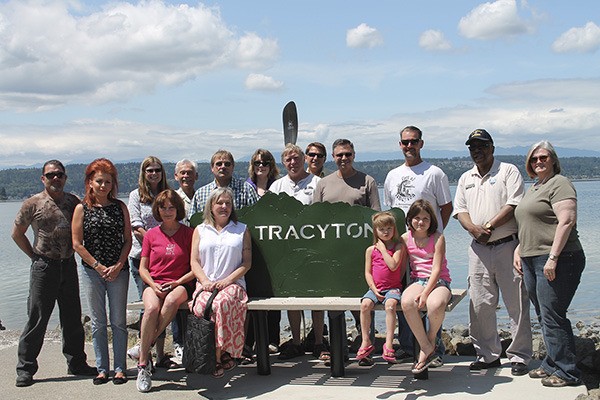 A group of Tracyton area residents and others gathered at the new bench at the Tracyton dock on Saturday to welcome kayakers to their area.