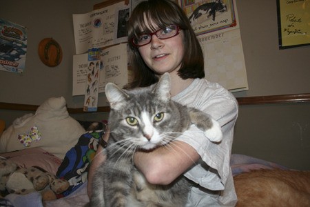 Seabeck 15-year-old Paula Tasso plays with her 8-year-old cat