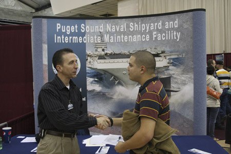 Glenn Jenne of the Puget Sound Naval Shipyard talks to an applicant at the shipyard's job fair Friday.