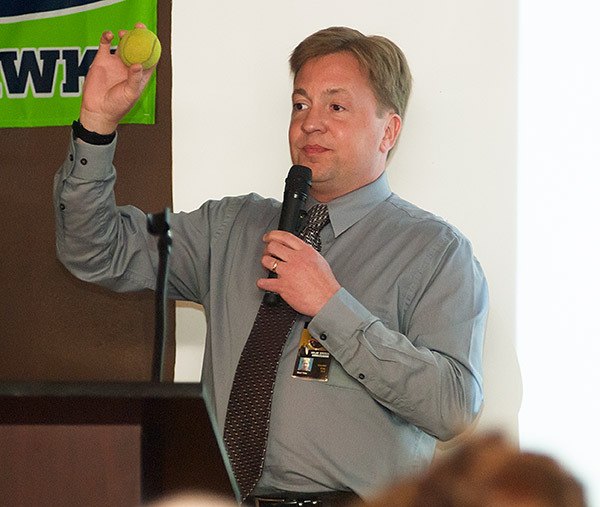 NASA Ambassador Ward Yohe holds up a tennis ball to represent the sun during his talk.