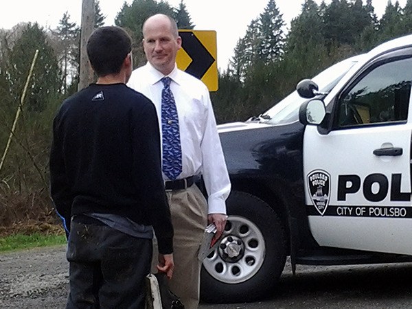 Deputy Chief John Halsted talks to a young person involved in a vehicle crash on Noll Road on Feb. 26