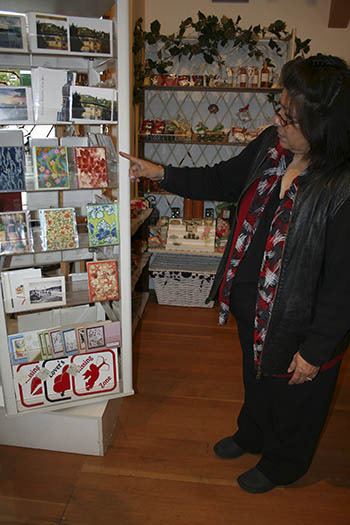 Josie Villas shows off some homemade cards in her shop.