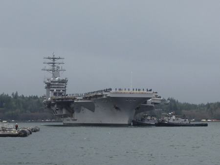 Tugboats steer the USS Nimitz into the Puget Sound Naval Shipyard in December