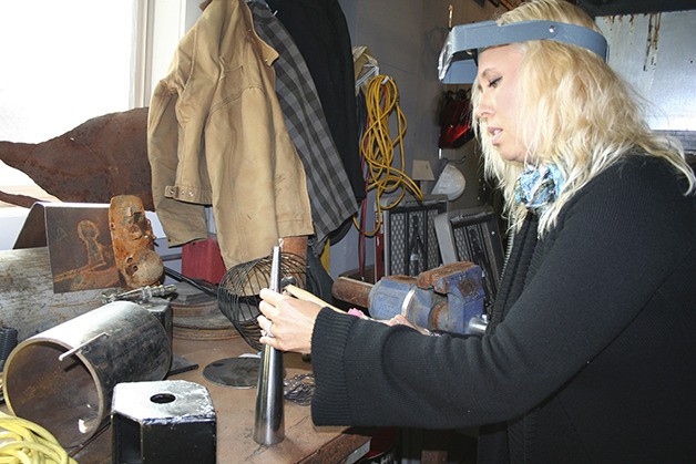 Tina Bright hammers a piece of metal for jewelry. Bright will be one of many local artists featured at the Art for the Cure benefit on Oct. 3.