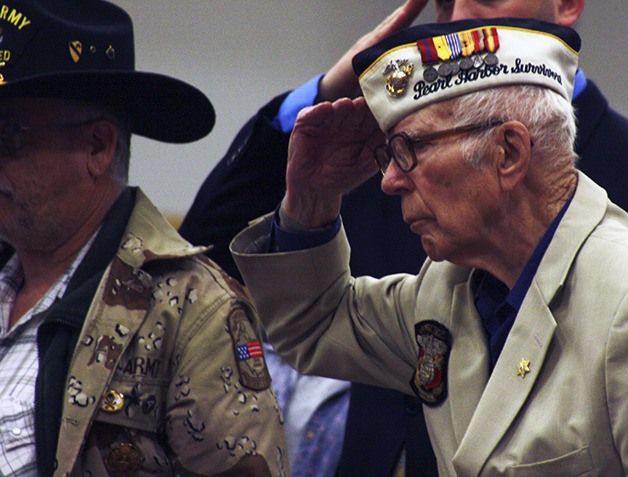 Pearl Harbor survivor Rocky Hoffman of Bremerton salutes the colors during Monday’s event at the fairgrounds.