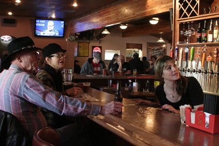 Bartender Jennifer Dowdle looks at the pull tabs with two visitors to Kelly’s 19th Hole Sports Bar and Grill Monday. The bar opened Feb. 4 with a new look and under new management.