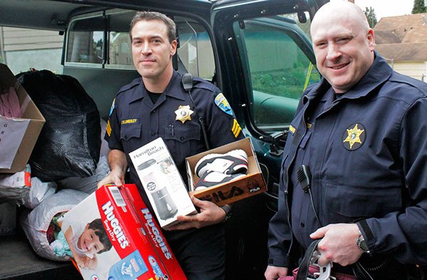 Sgt. Scott Billingsley and Rick Fitzpatrick of the Kitsap County Jail deliver a van full of donations to the Kitsap County YWCA in Bremerton March 9. The donations are the result of a month-long competition between divisions within the jail. Billingsley estimated that hundreds of pounds of goods were dontated