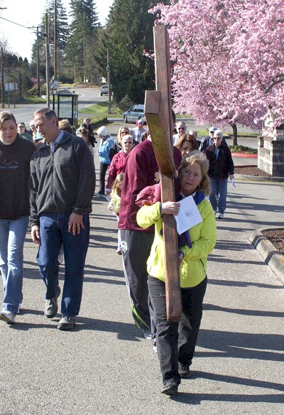 Tina Holmes carries the found of the cross during the 21st annual Cross Walk in Port Orchard. About 50 people participated in the event.