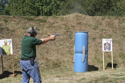 A contestant in the Nineteenth Annual Courage Classic Charity Shooting Match held by the Kitsap Rifle and Revolver Club in Bremerton advances through a staging area. The match was held by the club to raise money for charity