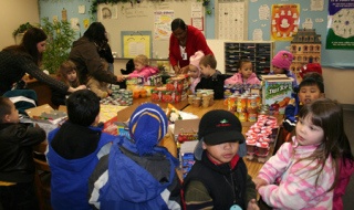 Children from Martha and Mary's Silverdale preschool sort through donated food to fill backpacks with at West Hills Elementary School in Bremerton as part of the Grace for Kids SnackPack program for needy families.