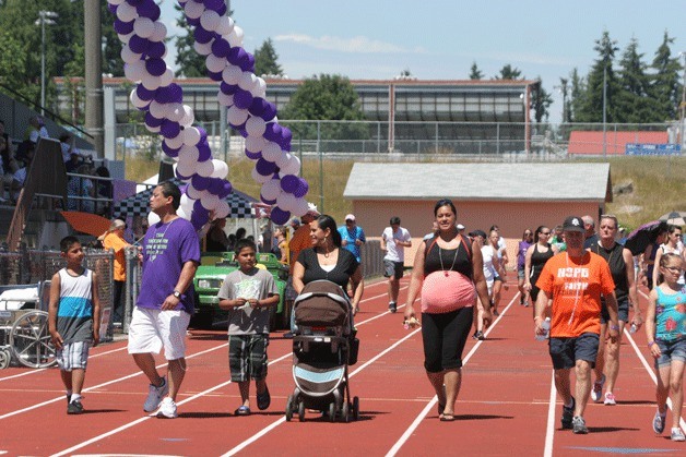 Walkers keep up the pace during Saturday's Relay for Life at Olympic High School. More than 700 walkers took part in the event