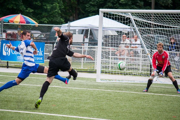 Pumas defender Zack Samson attempts to block a shot by a Highlanders player Sunday. Goalkeeper Aaron Fenlason made the save