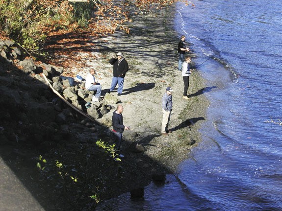 Fisherman cast their lines at the mouth of Curley Creek in the shadow of the Southworth Bridge