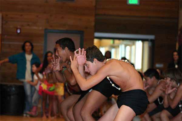 Students from Tahiti demonstrate a warrior dance during their visit to the Suquamish House of Awakening Culture.