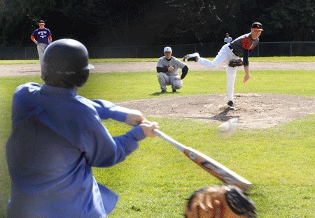 Central Kitsap High School senior Drew Vettleson throws a fastball to sports writer Wesley Remmer at a practice Tuesday.