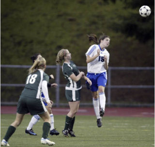 Olympic’s Jalyn Halstead (15) goes up for a header against Shadle Park Tuesday. Halsted and the Lady Trojans advanced to the state quarterfinals with a 1-0 victory. The team plays Shorecrest at Shoreline Stadium at 7 p.m. today