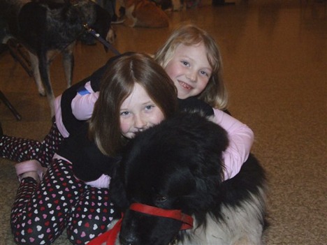 Sophie and Sasha Woltersdorf with their Newfoundland dog