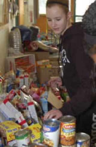 Julia Ratcliff sorts through food for the Peace Lutheran drive this week.