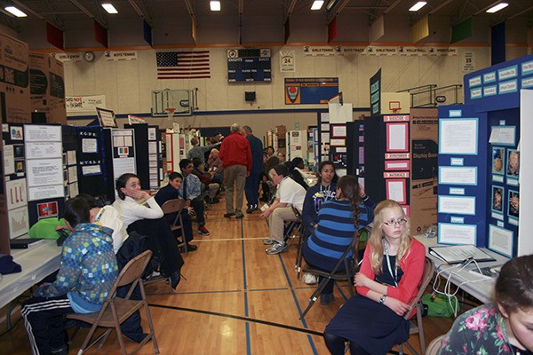 Seventh-graders wait patiently to have their individual projects judged at the state science and engineering fair last weekend in Bremerton.