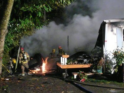 Firefighters work to extinguish a blaze at Illahee Shores Mobile Home Park in Bremerton Saturday.
