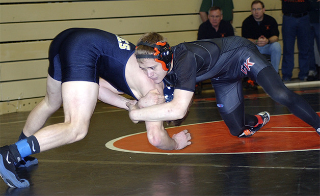 CK’s Calvin Fischer  wrestles Scott Bardell of Arlington.