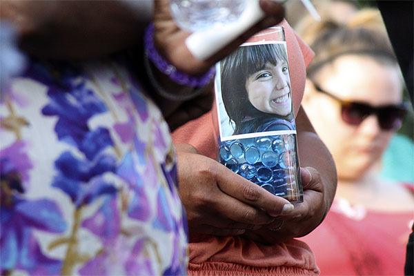 An image of Jenise Paulette Wright adorns a candle at the Aug. 8 vigil for the six-year-old East Bremerton girl whose body was found the day before.