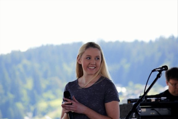 Rachel Clemons of North Kitsap High School is applauded after her performance of the National Anthem