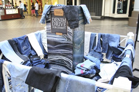 Denim donations pile up in the center court of the Kitsap Mall.