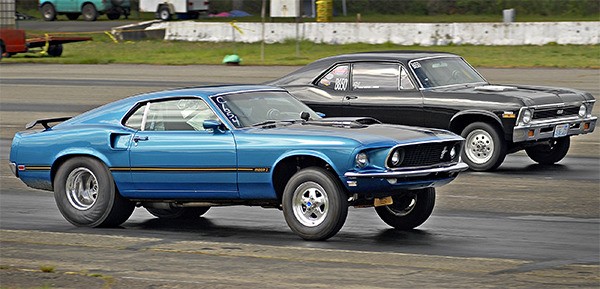 The front wheels of a Ford Mustang nearly lift off the ground as the car accelerates during a drag race at Bremerton Raceway on April 10.
