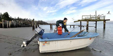 Bremerton fisherman Marty Mollison launches his dinghy from the Point No Point beach Tuesday. If approved