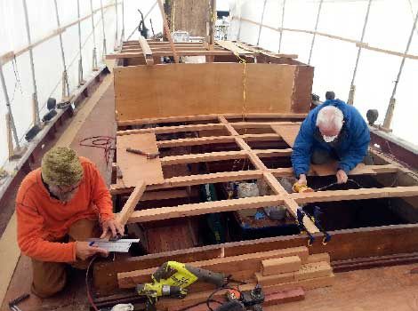 Shipwright Scotty Kimmitt and a Kitsap Maritime Heritage Foundation board member Skip Nordal work on the restoration of Fiddler’s Dream
