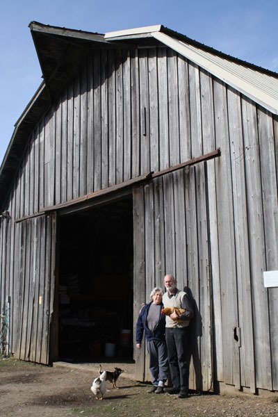 Marilyn and Cliff Holt stand at their barn that was recently named a Heritage barn.