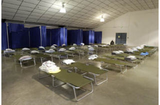 Rows of beds line the inside of the weather shelter set up at the President’s Hall at the Kitsap County Fairgrounds.