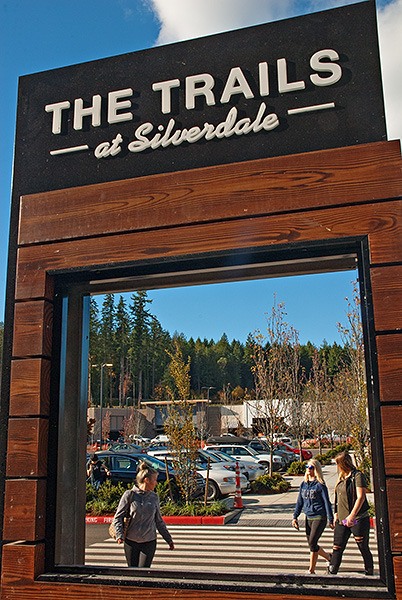 An unfinished sign at the new Trails at Silverdale frames Port Orchard shoppers Tia Williams